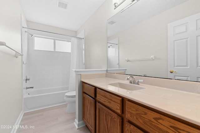 full bathroom featuring shower / tub combo with curtain, vanity, wood-type flooring, and toilet