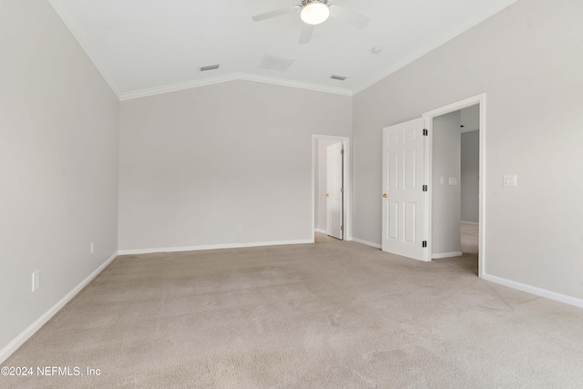 spare room with light colored carpet, vaulted ceiling, ceiling fan, and crown molding