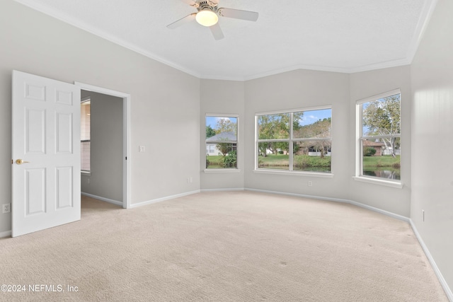 unfurnished room with light carpet, lofted ceiling, ceiling fan, and crown molding