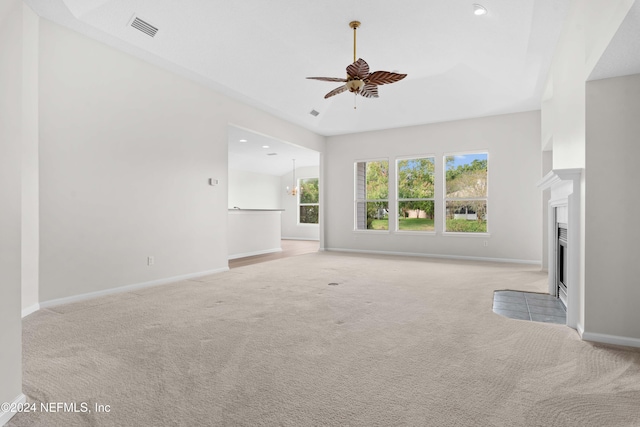 unfurnished living room featuring ceiling fan and light colored carpet