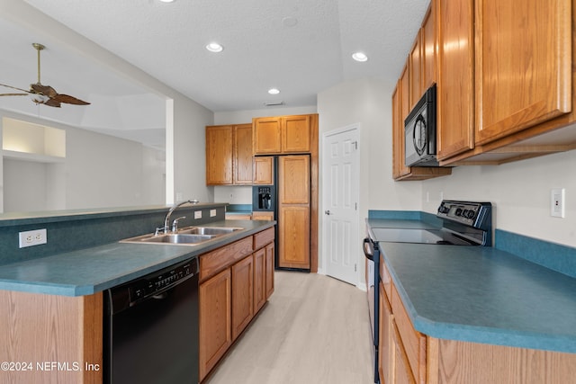 kitchen featuring a textured ceiling, ceiling fan, sink, black appliances, and light hardwood / wood-style flooring