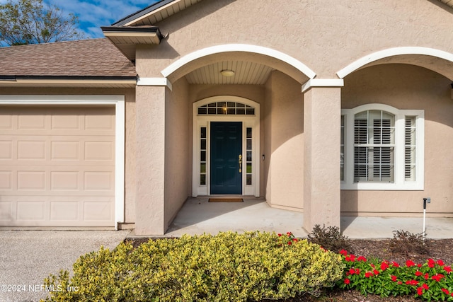 property entrance with a garage