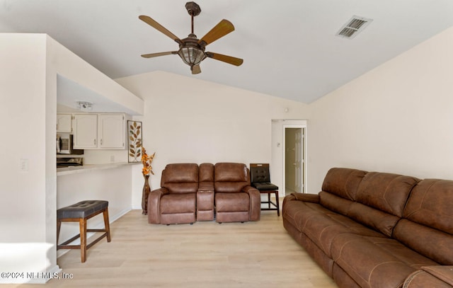 living room with vaulted ceiling, light hardwood / wood-style flooring, and ceiling fan