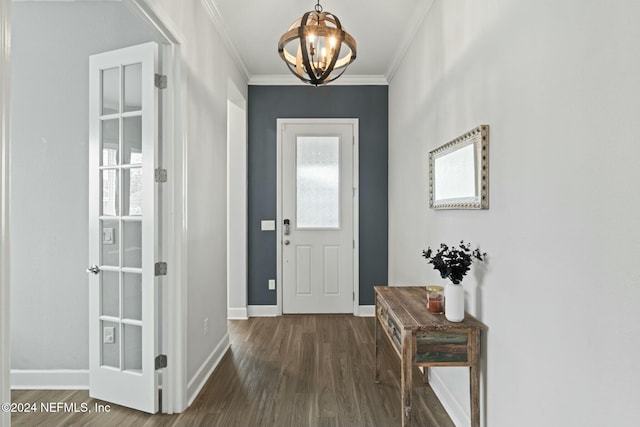 doorway to outside featuring dark hardwood / wood-style flooring, an inviting chandelier, and ornamental molding