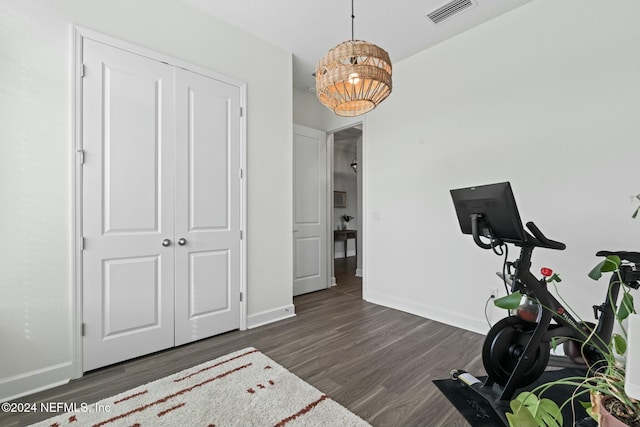 exercise room with dark hardwood / wood-style floors