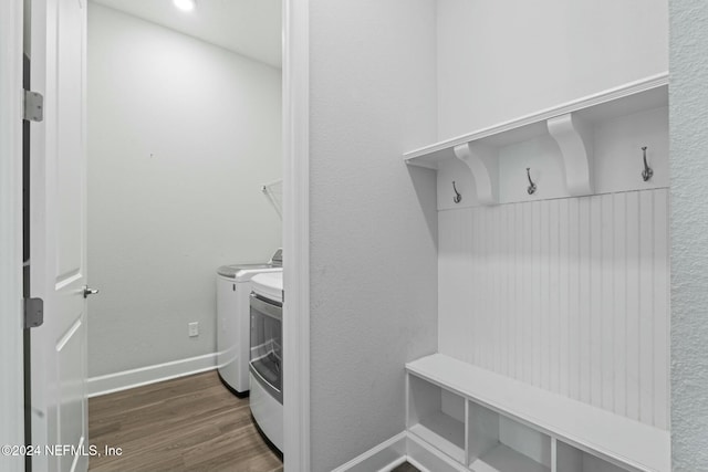 interior space with washing machine and dryer and dark hardwood / wood-style floors