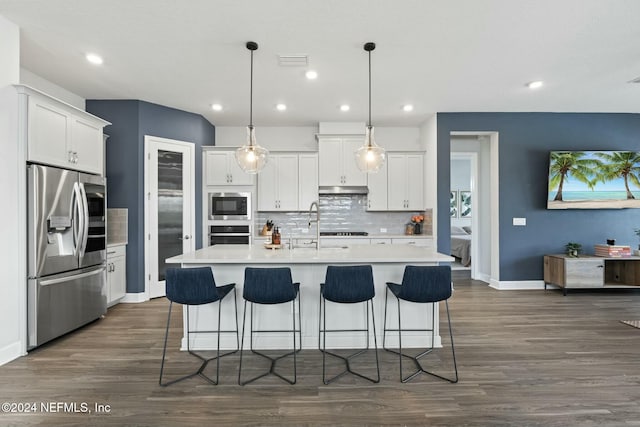 kitchen featuring pendant lighting, white cabinets, and stainless steel appliances