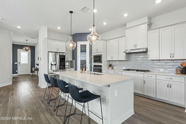 kitchen with white cabinetry, sink, dark hardwood / wood-style flooring, decorative light fixtures, and a kitchen island with sink