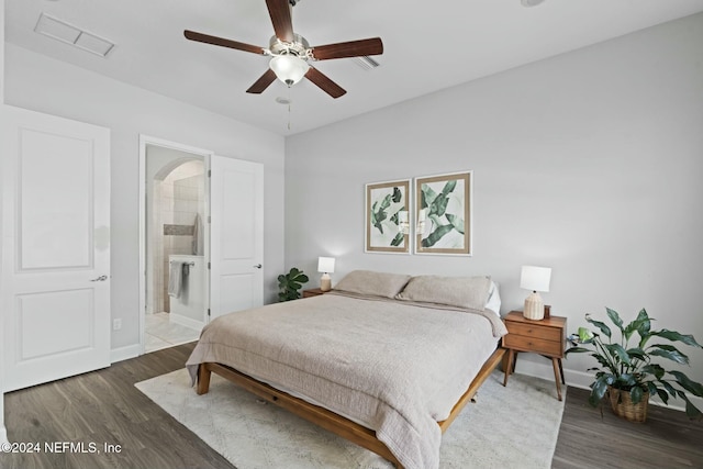 bedroom featuring connected bathroom, ceiling fan, and dark wood-type flooring