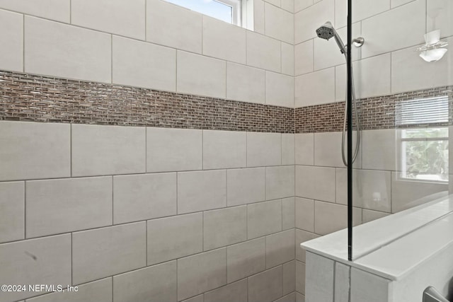 bathroom with tiled shower