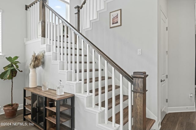 staircase with hardwood / wood-style floors