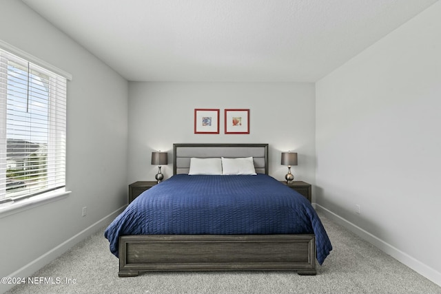 bedroom with multiple windows and carpet floors