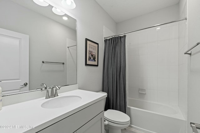 full bathroom with shower / tub combo, vanity, and toilet