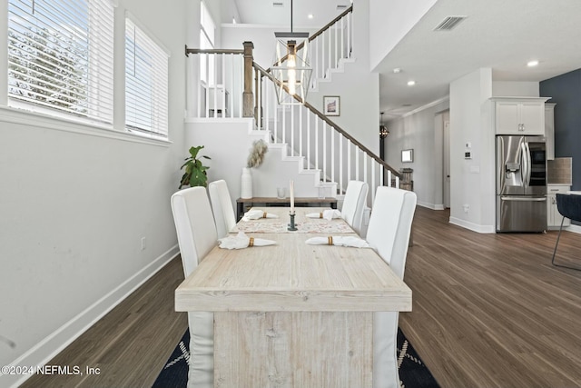 dining space with dark hardwood / wood-style floors