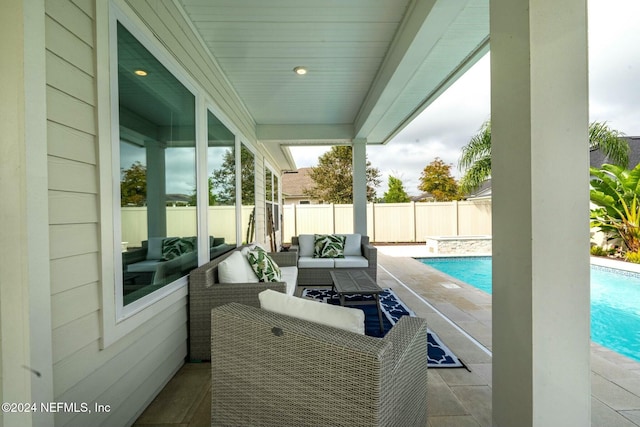 view of patio / terrace featuring a fenced in pool and an outdoor living space