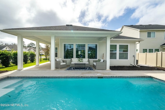 back of house with a fenced in pool, a patio area, and an outdoor living space