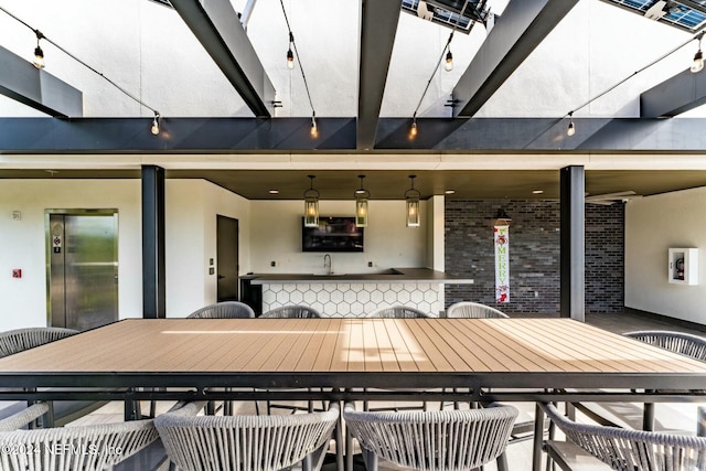 view of patio / terrace with elevator and sink