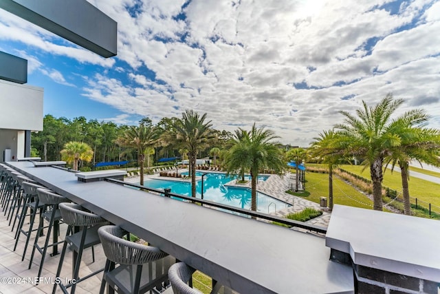 view of pool featuring a bar