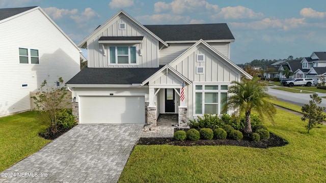 view of front of house with a front yard and a garage