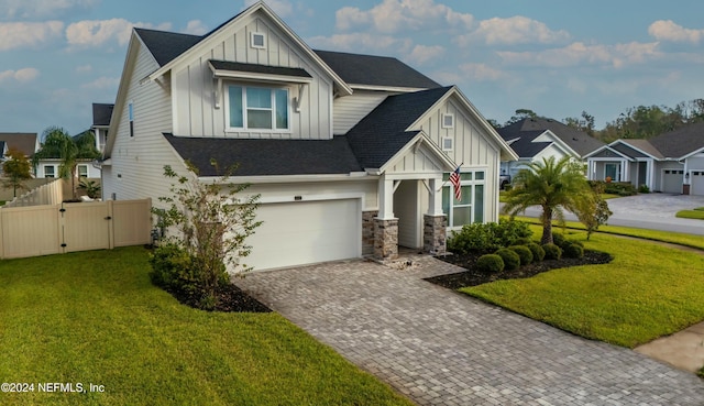 view of front of home with a front yard and a garage