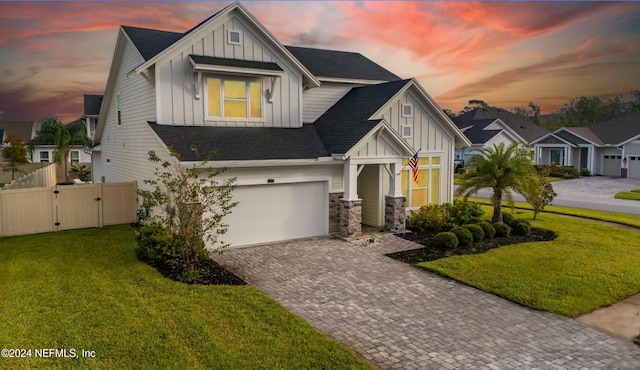 view of front of property with a garage and a yard