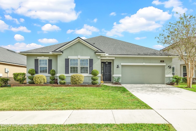 single story home featuring a front lawn and a garage