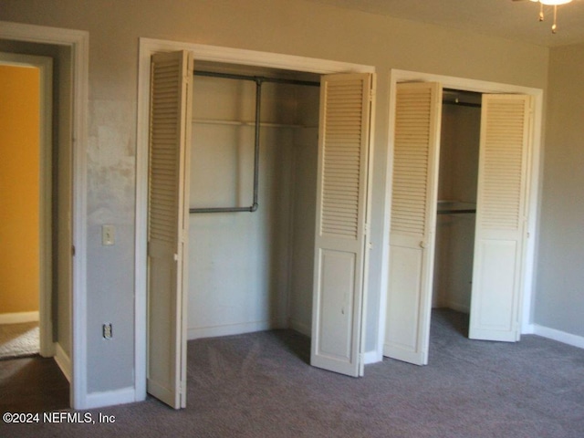 unfurnished bedroom with dark colored carpet