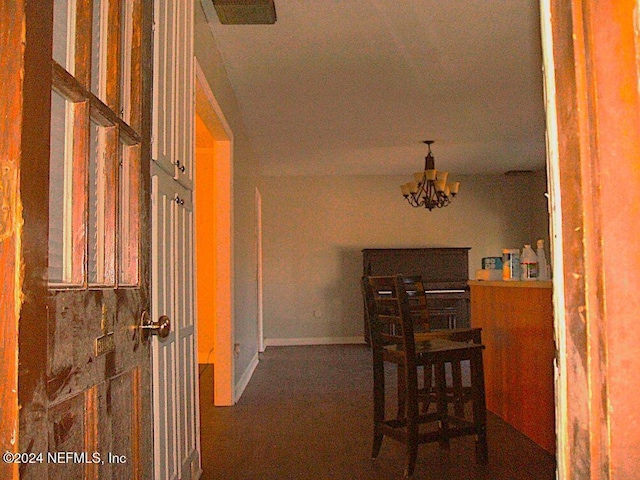 hallway featuring an inviting chandelier