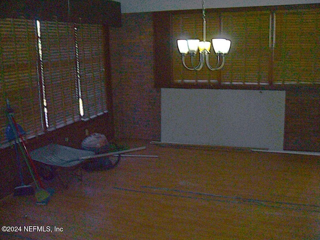 unfurnished dining area featuring an inviting chandelier