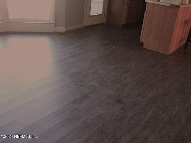 1113 Fieldcrest Rd, Jasper, FL 32052 - kitchen featuring dark wood-style flooring, healthy amount of natural light, and white cabinets
