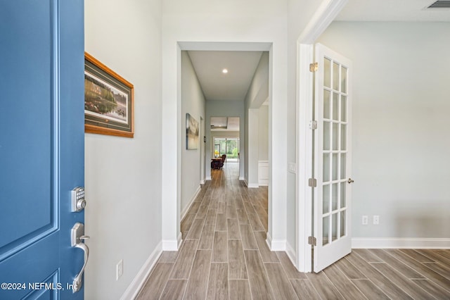 corridor with wood-type flooring