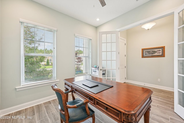 office area featuring french doors, light wood-type flooring, and ceiling fan