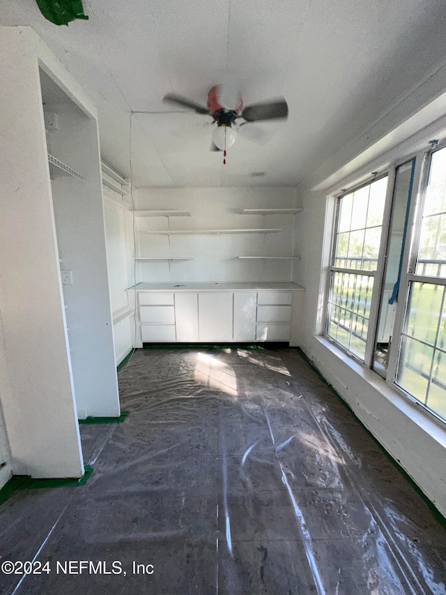 empty room featuring a textured ceiling and ceiling fan