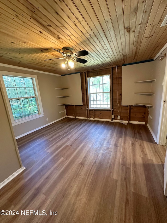 interior space featuring wood-type flooring, wooden ceiling, and ornamental molding