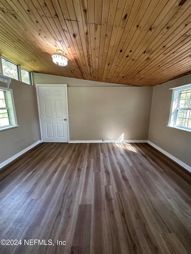 empty room featuring an inviting chandelier, wood ceiling, and wood-type flooring