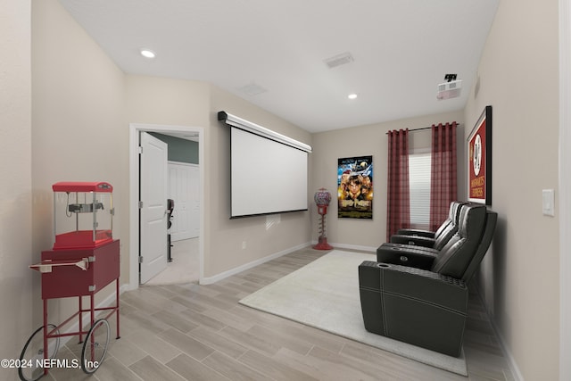 cinema room with light hardwood / wood-style flooring