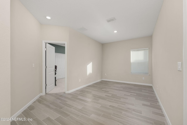 spare room with light hardwood / wood-style floors