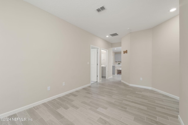 spare room featuring light hardwood / wood-style flooring