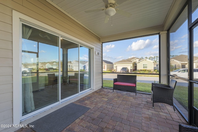 sunroom with a healthy amount of sunlight and ceiling fan