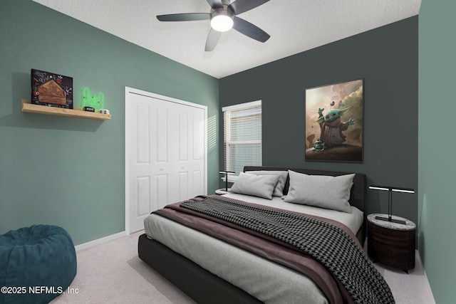 carpeted bedroom featuring a closet and ceiling fan