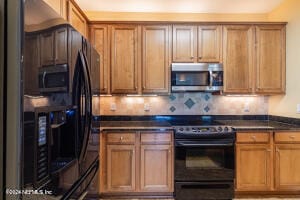 kitchen featuring tasteful backsplash and black electric range