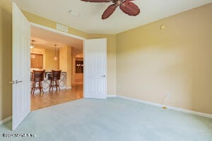 unfurnished room featuring carpet and ceiling fan