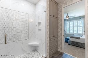 bathroom with an enclosed shower and ceiling fan