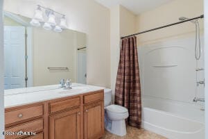 full bathroom with shower / tub combo with curtain, vanity, and toilet