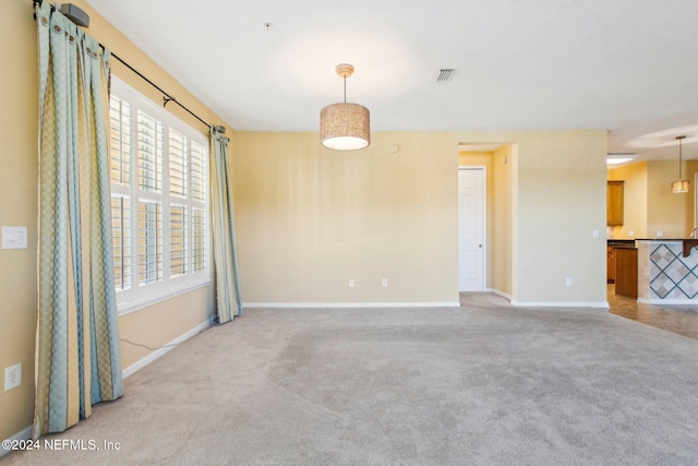 unfurnished room featuring light colored carpet