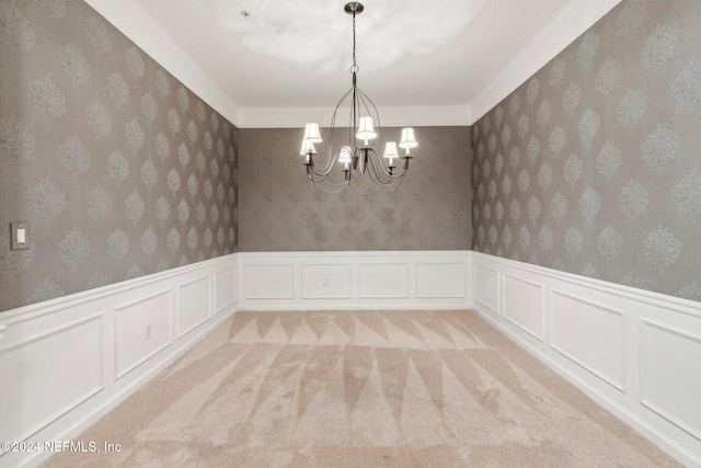 unfurnished room with a chandelier, light colored carpet, and crown molding