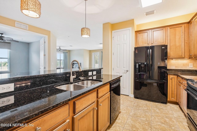 kitchen featuring dark stone counters, ceiling fan, sink, black appliances, and decorative light fixtures