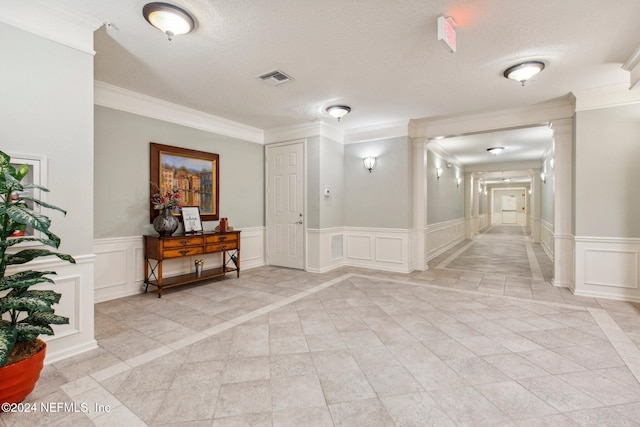 hall featuring crown molding and a textured ceiling