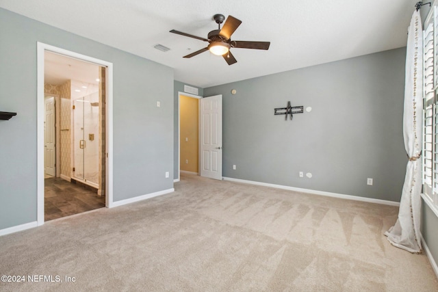 unfurnished bedroom with carpet, ensuite bathroom, and ceiling fan