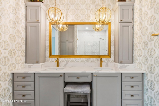 bathroom featuring a shower, vanity, and a notable chandelier